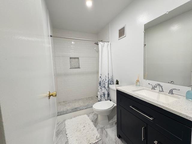 full bath with tiled shower, vanity, toilet, marble finish floor, and visible vents