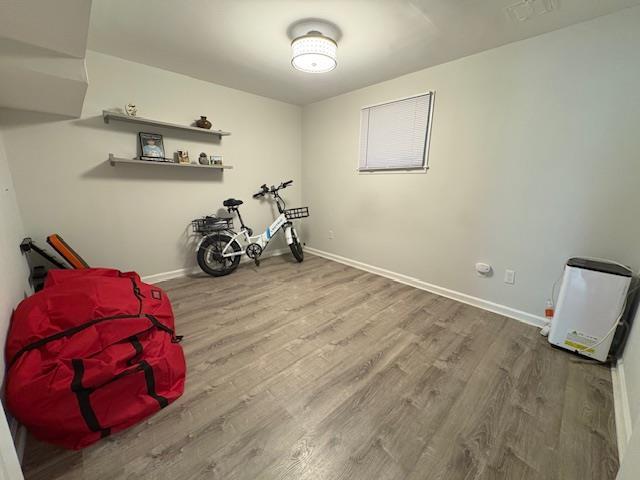 interior space featuring wood finished floors and baseboards
