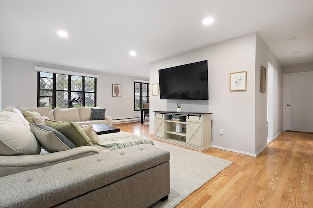 living room with recessed lighting, baseboards, baseboard heating, and light wood finished floors
