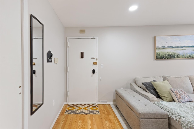 entryway featuring baseboards, recessed lighting, and light wood-style flooring