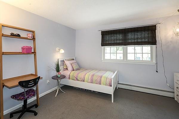 carpeted bedroom with a baseboard heating unit