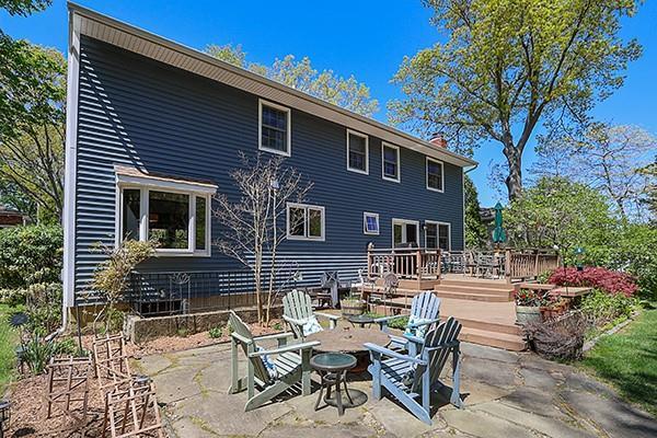 back of house with a patio, a chimney, and a deck