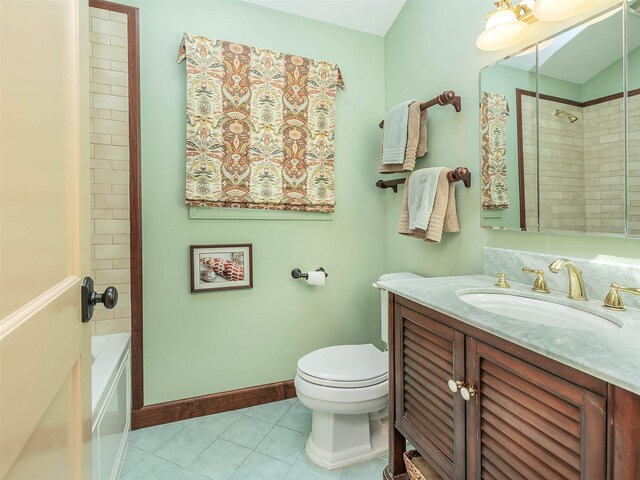 bathroom with vanity, tile patterned flooring, baseboards, and toilet