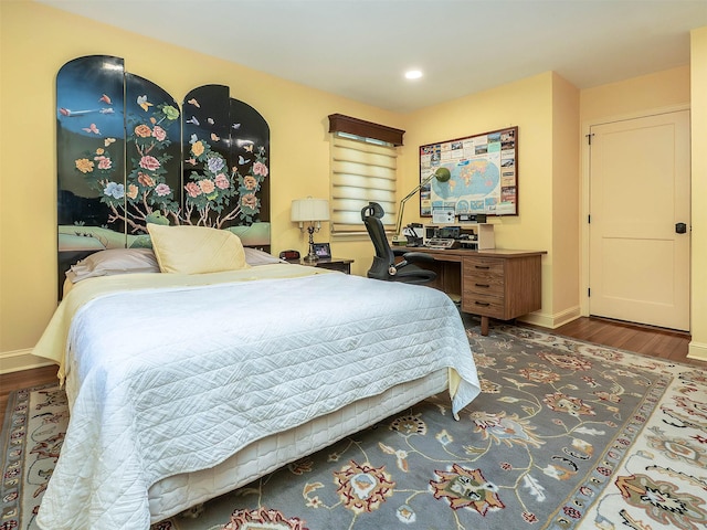 bedroom with baseboards, recessed lighting, and wood finished floors