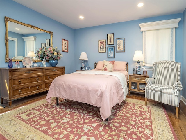 bedroom with recessed lighting and wood finished floors