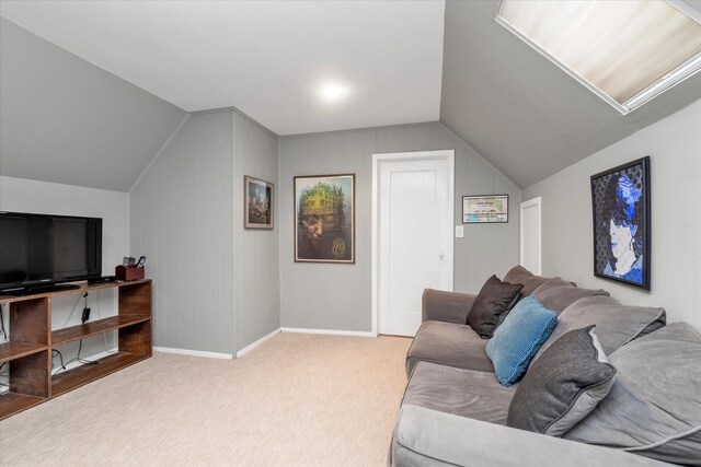 living room with vaulted ceiling, carpet, and baseboards