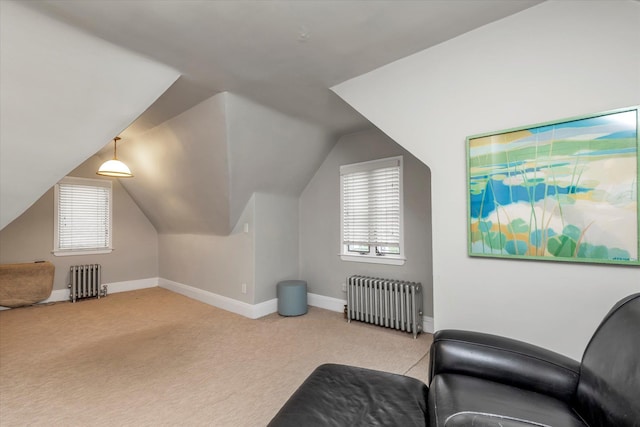 bonus room featuring radiator, light carpet, plenty of natural light, and vaulted ceiling