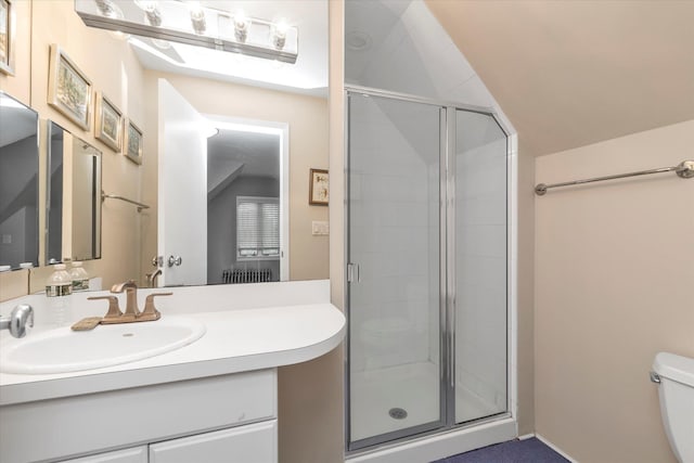 full bath with a stall shower, toilet, vaulted ceiling, and vanity