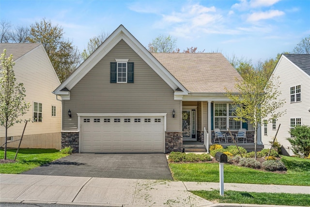 13 Sage Ct, Middletown, NY 10940 - view of front of home with stone siding, a garage, aphalt driveway, a porch, and a front yard