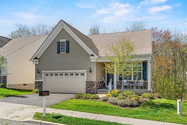 13 Sage Ct, Middletown, NY 10940 - view of front of house featuring covered porch, aphalt driveway, a garage, a front lawn, and a shingled roof