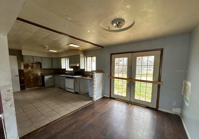 73 4th St, Brentwood, NY 11717 - kitchen with french doors, visible vents, wood finished floors, baseboards, and dishwashing machine