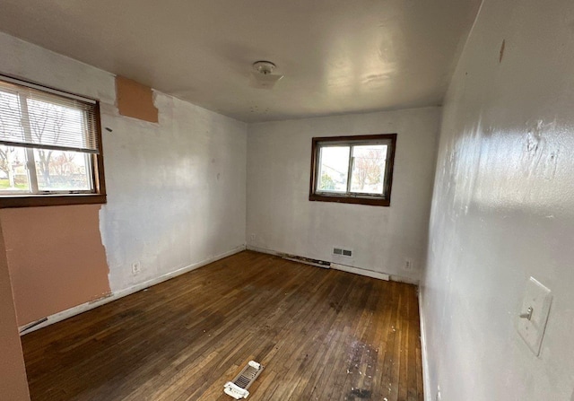 73 4th St, Brentwood, NY 11717 - empty room featuring visible vents, baseboards, and hardwood / wood-style flooring