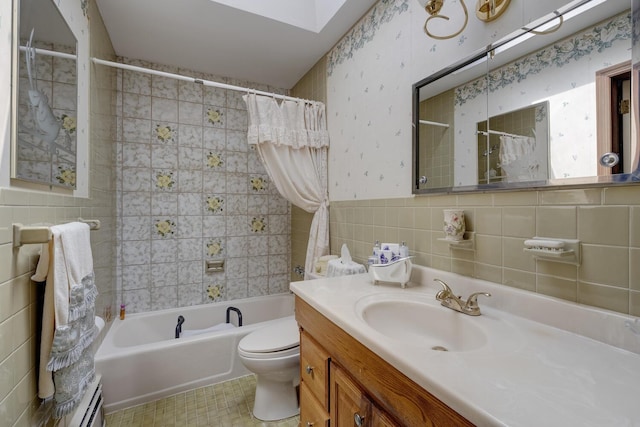 bathroom with tile walls, shower / bath combo, vanity, tile patterned floors, and toilet