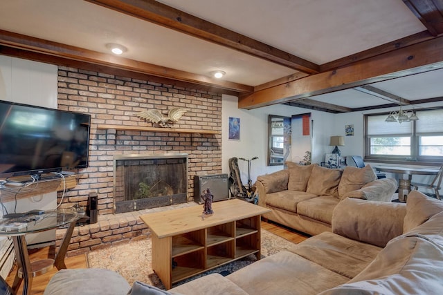 living room with a brick fireplace and beamed ceiling