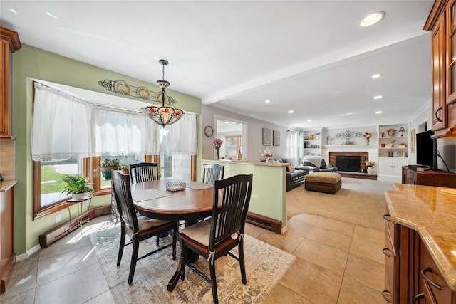 dining space featuring a brick fireplace, recessed lighting, baseboards, and light tile patterned floors