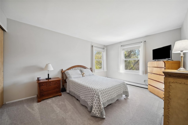 carpeted bedroom with baseboards and a baseboard heating unit