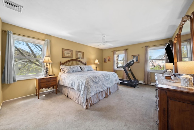 bedroom featuring visible vents, baseboards, ceiling fan, and light colored carpet
