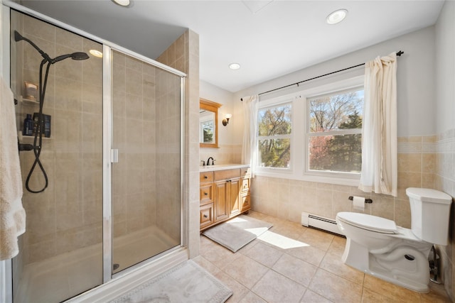 full bathroom featuring toilet, tile patterned floors, tile walls, a baseboard heating unit, and a stall shower