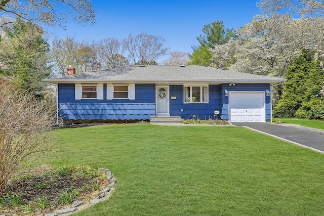 ranch-style house featuring a chimney, aphalt driveway, roof with shingles, a front lawn, and an attached garage