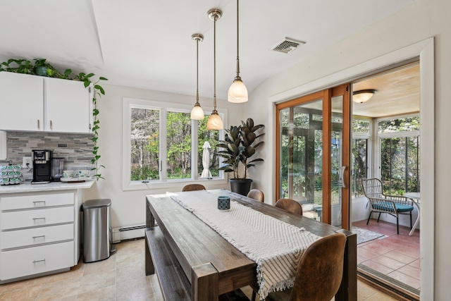 dining space featuring visible vents, a baseboard heating unit, and light tile patterned flooring