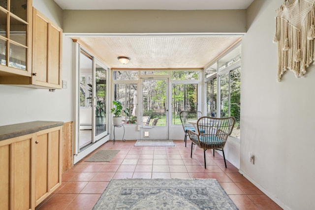 sunroom featuring french doors and tile patterned flooring