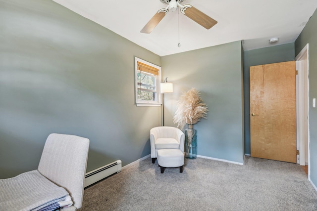 living area with a ceiling fan, baseboards, a baseboard heating unit, and carpet floors