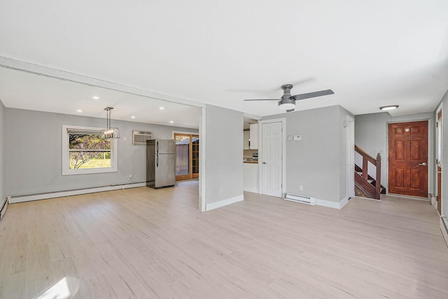 unfurnished living room with a baseboard heating unit, baseboard heating, stairs, light wood-style floors, and recessed lighting