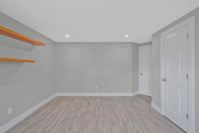 unfurnished room with wood finished floors, baseboards, and recessed lighting