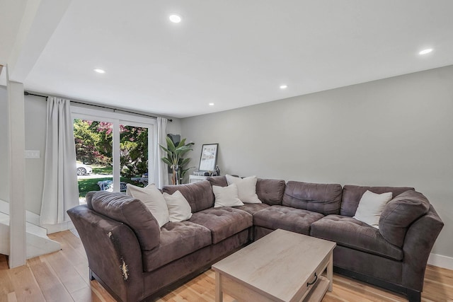 living area with recessed lighting and light wood-style floors