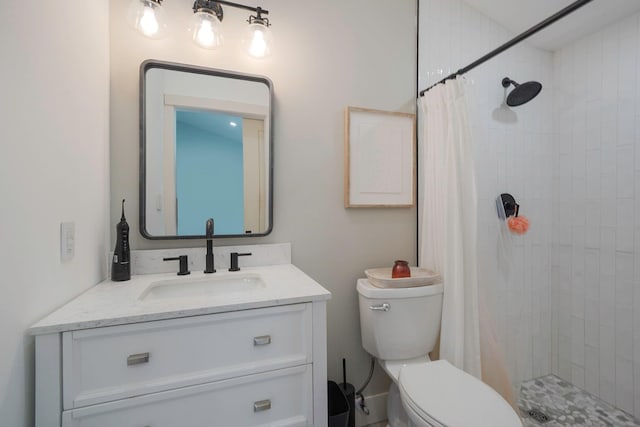 full bath with toilet, a stall shower, and vanity