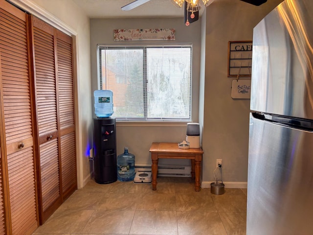 interior space featuring baseboards, ceiling fan, baseboard heating, and tile patterned flooring