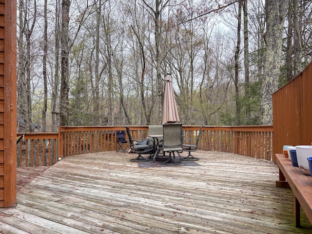 wooden terrace with outdoor dining area