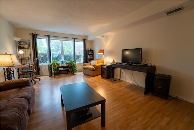 living area featuring wood finished floors and visible vents