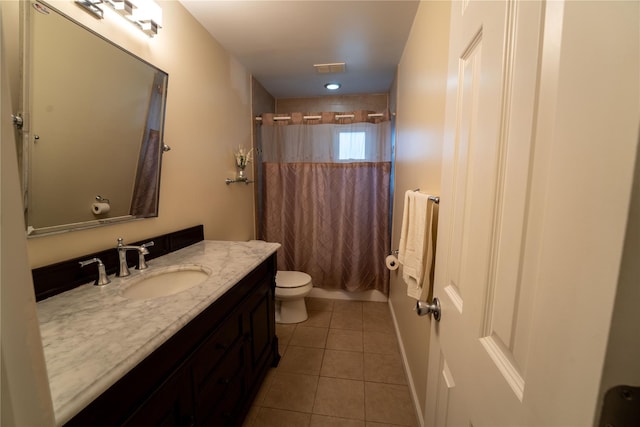bathroom with vanity, visible vents, shower / bath combo with shower curtain, toilet, and tile patterned floors