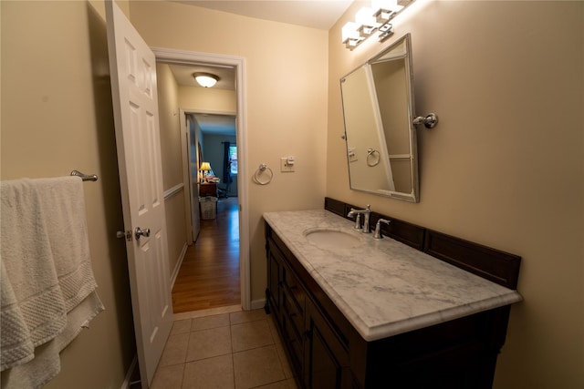 bathroom featuring vanity, baseboards, and tile patterned floors