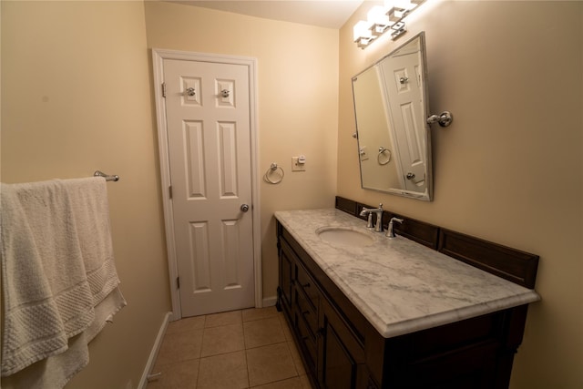 bathroom with vanity, tile patterned flooring, and baseboards