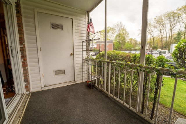 balcony featuring covered porch and visible vents