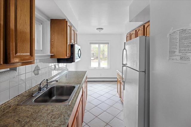 2533 Francis Lewis Blvd, Whitestone, NY 11358 - kitchen featuring freestanding refrigerator, a baseboard radiator, a sink, and brown cabinetry