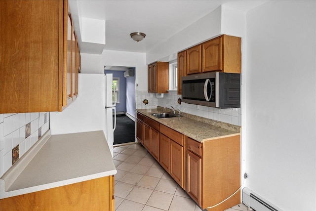 2533 Francis Lewis Blvd, Whitestone, NY 11358 - kitchen featuring stainless steel microwave, a baseboard radiator, brown cabinetry, and backsplash