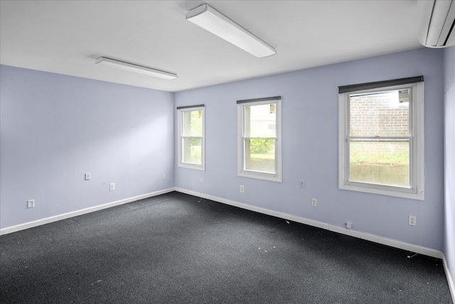 2533 Francis Lewis Blvd, Whitestone, NY 11358 - spare room featuring an AC wall unit, dark carpet, and baseboards