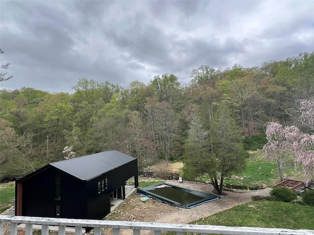 view of storm shelter featuring a view of trees