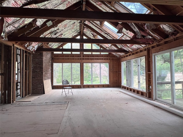 misc room featuring lofted ceiling with skylight
