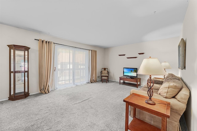 carpeted living room with baseboards