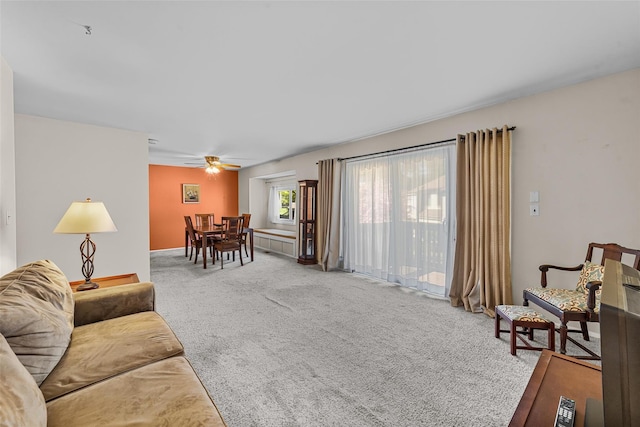 carpeted living room with a ceiling fan