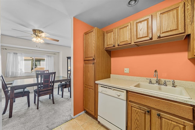 kitchen with a ceiling fan, light tile patterned flooring, white dishwasher, light countertops, and a sink