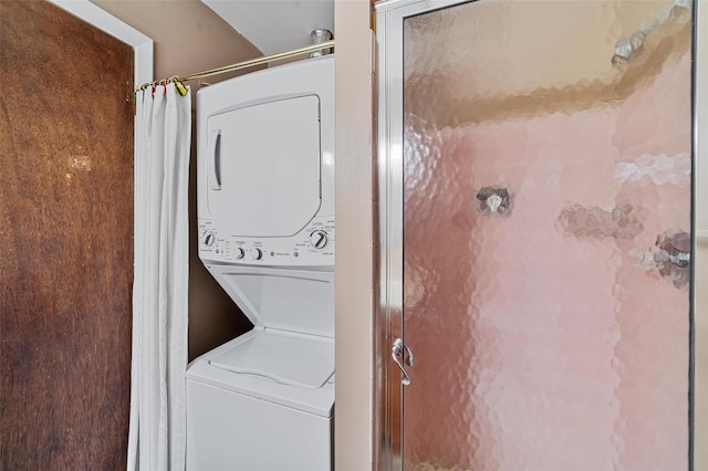 laundry area featuring stacked washer / dryer