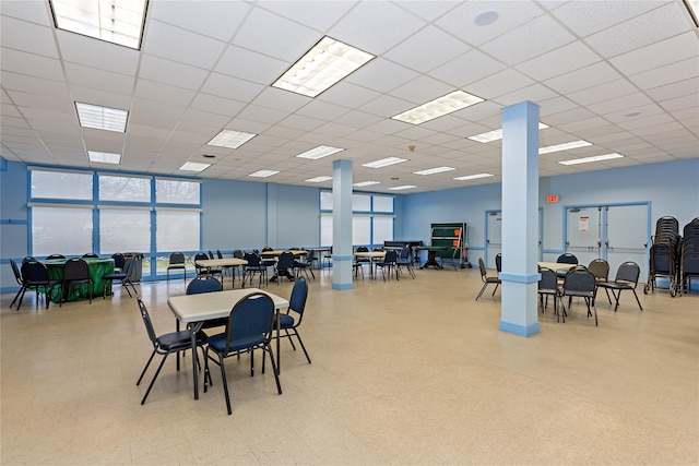 dining room featuring a drop ceiling and tile patterned floors
