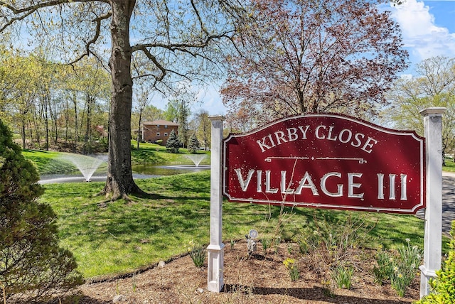 community / neighborhood sign with a lawn