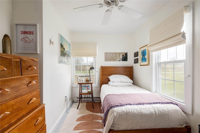 bedroom featuring baseboards, a ceiling fan, and a baseboard radiator