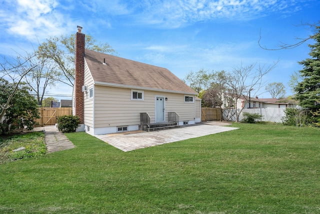 back of house with a lawn, a patio, fence, and a chimney
